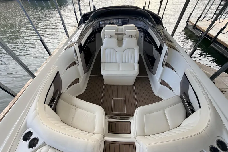 Slide: The Image of Luxurious interior of a 2004 Cobalt 343 boat with white seating and wood accents. - 31