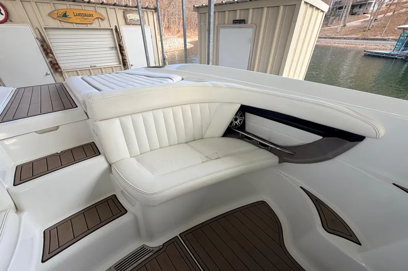 Slide: The Image of Luxurious seating area on a 2004 Cobalt 343 boat, featuring white upholstery and wood accents. - 34