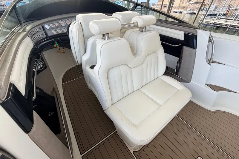 Slide: The Image of Interior of a 2004 Cobalt 343 boat with white leather seating and wood flooring. - 39