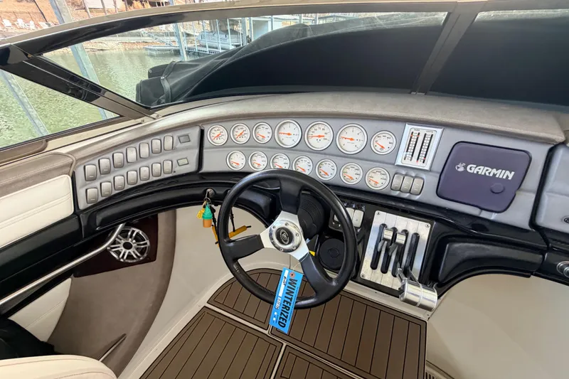 Slide: The Image of Dashboard of a 2004 Cobalt 343 boat with steering wheel and Garmin navigation system. - 43