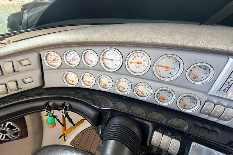 Slide: The Image of Dashboard of a 2004 Cobalt 343 boat with multiple gauges and controls. - 48