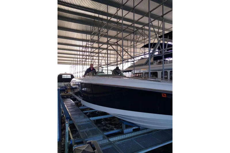 Slide: The Image of 2004 Cobalt 343 boat in a covered marina, side view. - 5