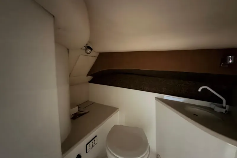 Slide: The Image of Interior of 2004 Cobalt 343 boat bathroom with toilet and sink. - 51