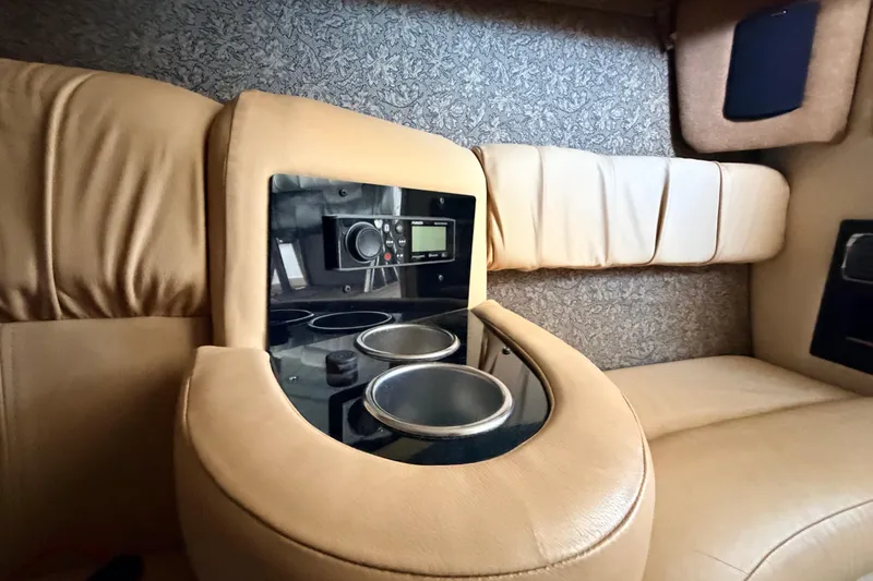 Slide: The Image of 2004 Cobalt 343 interior with beige leather seating and built-in cup holders. - 53