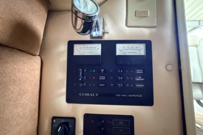 Slide: The Image of Control panel of a 2004 Cobalt 343 boat, featuring AC voltage and amperage gauges. - 55
