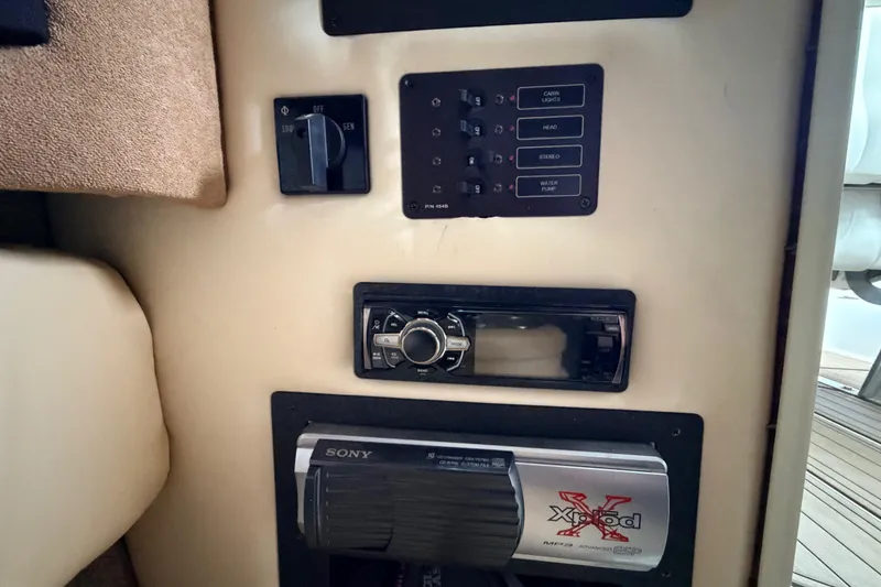 Slide: The Image of Control panel of a 2004 Cobalt 343 boat with audio system and switches. - 56