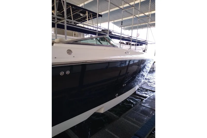 Slide: The Image of 2004 Cobalt 343 boat docked in a marina, side view. - 7