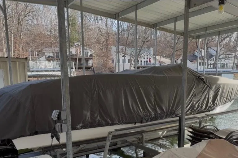 Slide: The Image of Covered 2004 Cobalt 343 boat docked in a sheltered marina area. - 8