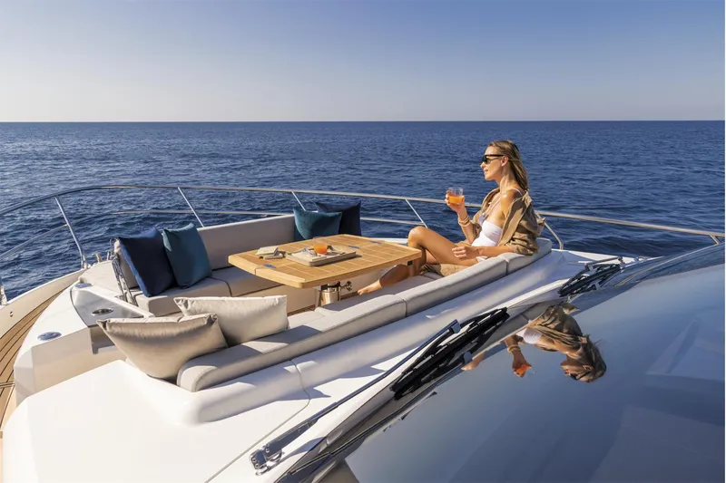 Slide: The Image of Woman relaxing on 2025 Absolute 60 Fly Co Ownership yacht, enjoying a drink at sea. - 5
