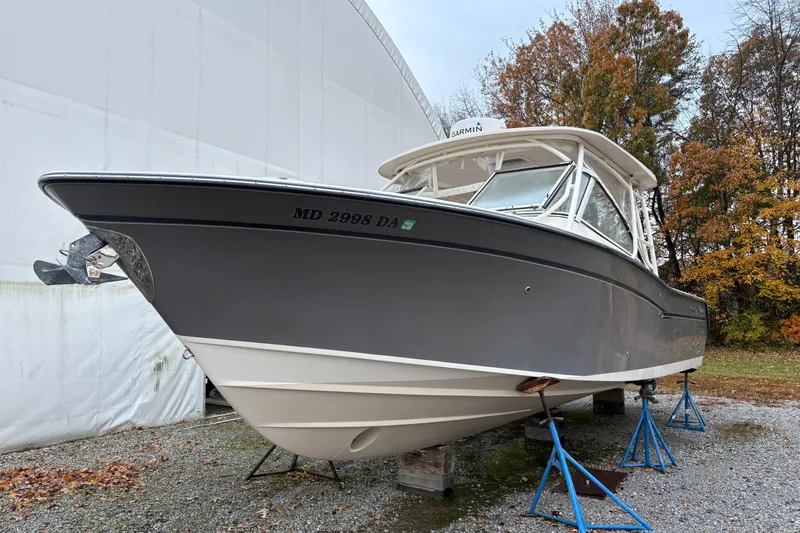 The Image of 2017 Grady-White Freedom 307 boat on stands, outdoor setting, autumn trees in background. - 0