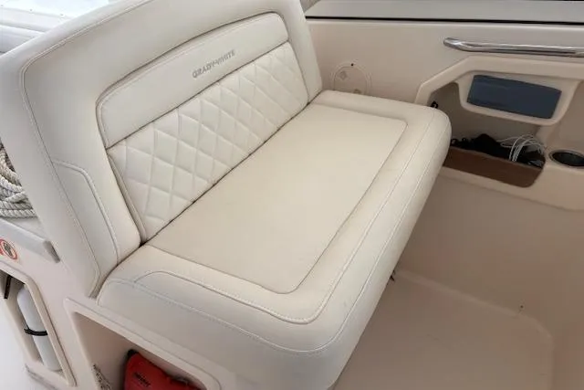 Slide: The Image of 2017 Grady-White Freedom 307 boat interior with cushioned seating and storage. - 13