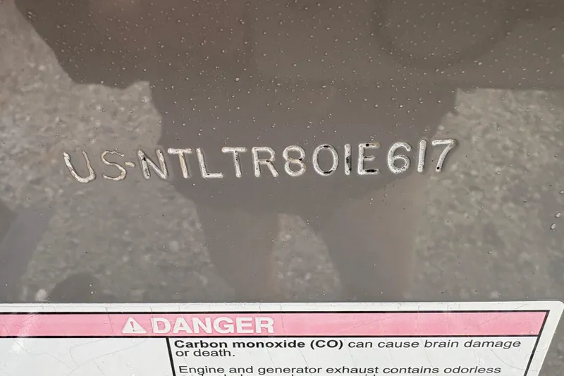 Slide: The Image of Hull identification number on 2017 Grady-White Freedom 307 boat with safety warning label. - 17
