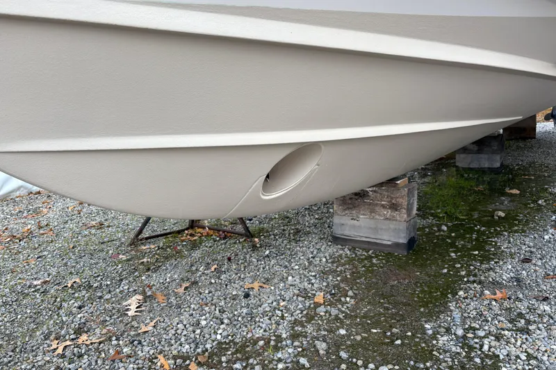 Slide: The Image of 2017 Grady-White Freedom 307 boat hull on gravel, supported by blocks. - 4