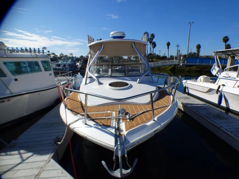 Slide: The Image of 2016 Sea Fox 256 Voyager boat docked at marina under clear blue sky. - 10