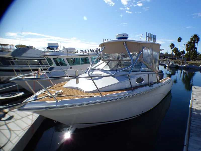 Slide: The Image of 2016 Sea Fox 256 Voyager boat docked at marina under clear blue sky. - 12