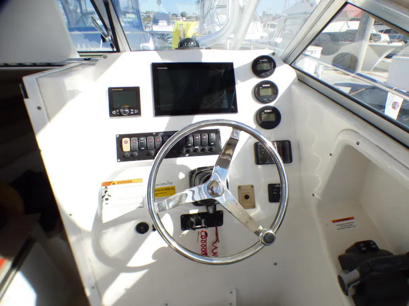 Slide: The Image of Helm of 2016 Sea Fox 256 Voyager boat with steering wheel and control panel. - 17