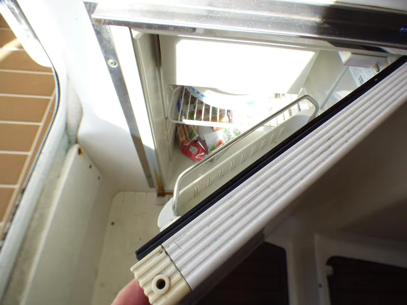 Slide: The Image of Open refrigerator on 2016 Sea Fox 256 Voyager boat, showing interior contents. - 24