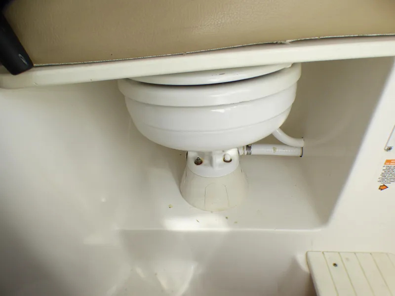 Slide: The Image of 2016 Sea Fox 256 Voyager boat interior detail, featuring a white marine toilet. - 25