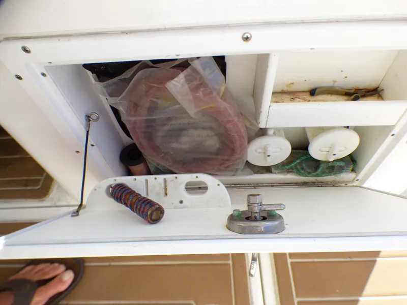 Slide: The Image of Storage compartment on a 2016 Sea Fox 256 Voyager boat with various items. - 28