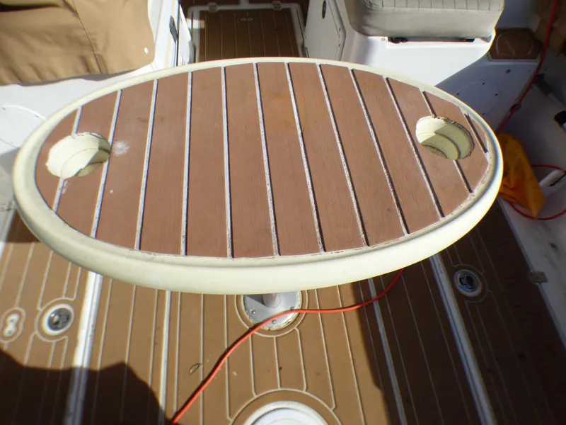Slide: The Image of Oval table with cup holders on a 2016 Sea Fox 256 Voyager boat deck. - 30