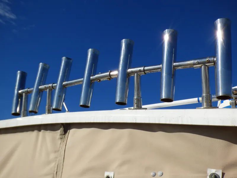 Slide: The Image of Rod holders on a 2016 Sea Fox 256 Voyager boat against a clear blue sky. - 33