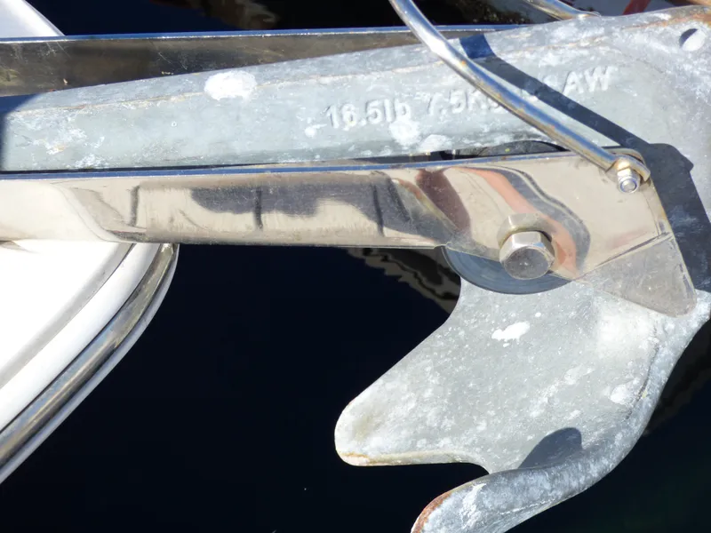 Slide: The Image of Anchor detail of 2016 Sea Fox 256 Voyager boat, showing metal components and water reflection. - 35