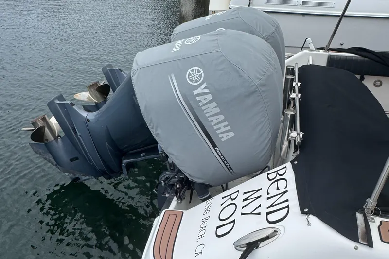 Slide: The Image of 2004 Robalo R265 Walkaround with Yamaha outboard motors, docked at a marina. - 19