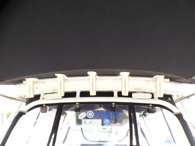 Slide: The Image of 2004 Robalo R265 Walkaround boat interior with rod holders and windshield view. - 25
