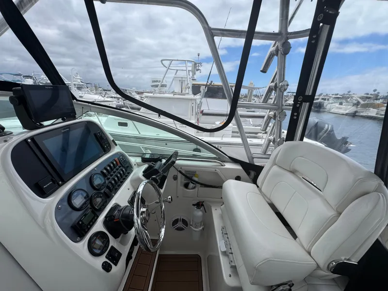 Slide: The Image of 2004 Robalo R265 Walkaround boat interior with steering wheel and control panel. - 28