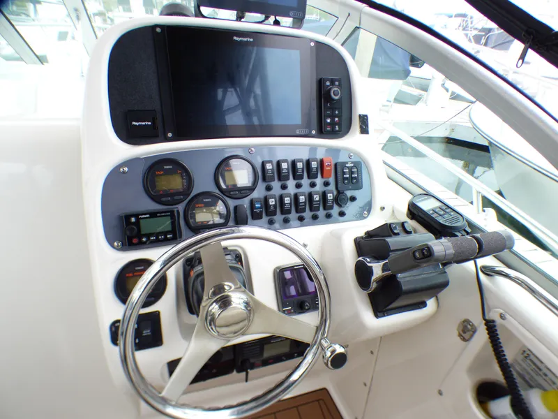 Slide: The Image of 2004 Robalo R265 Walkaround boat dashboard with steering wheel and control panel. - 29