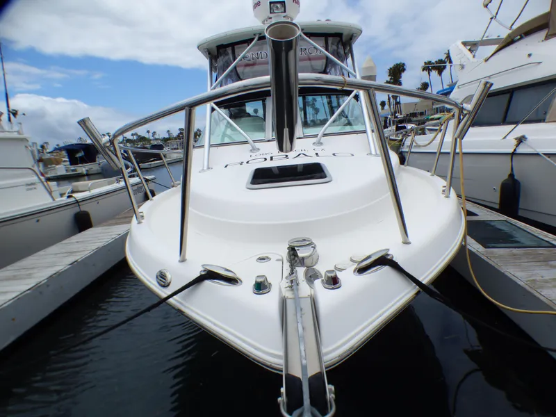 Slide: The Image of 2004 Robalo R265 Walkaround boat docked at marina, front view. - 3