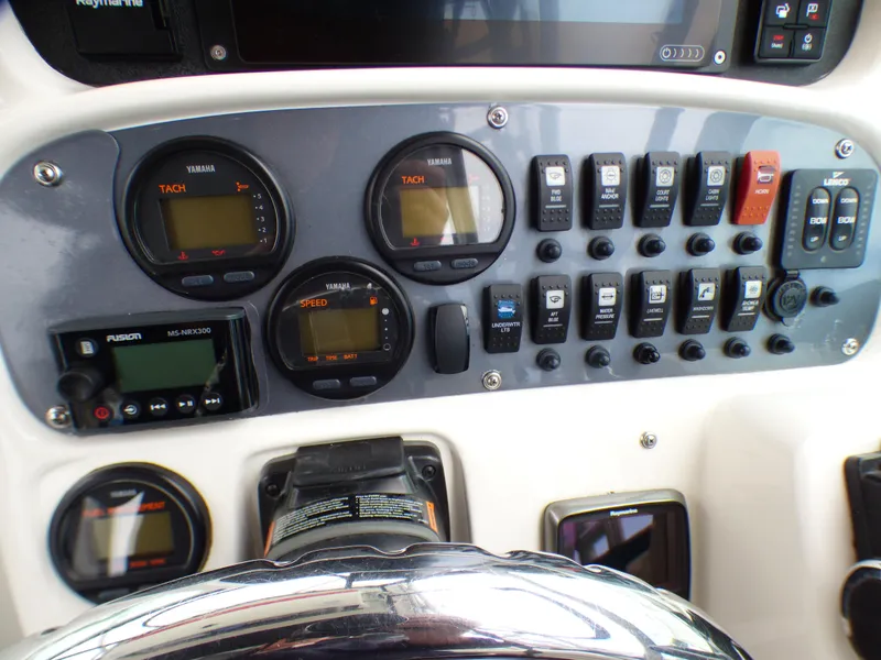 Slide: The Image of Control panel of a 2004 Robalo R265 Walkaround boat with gauges and switches. - 32