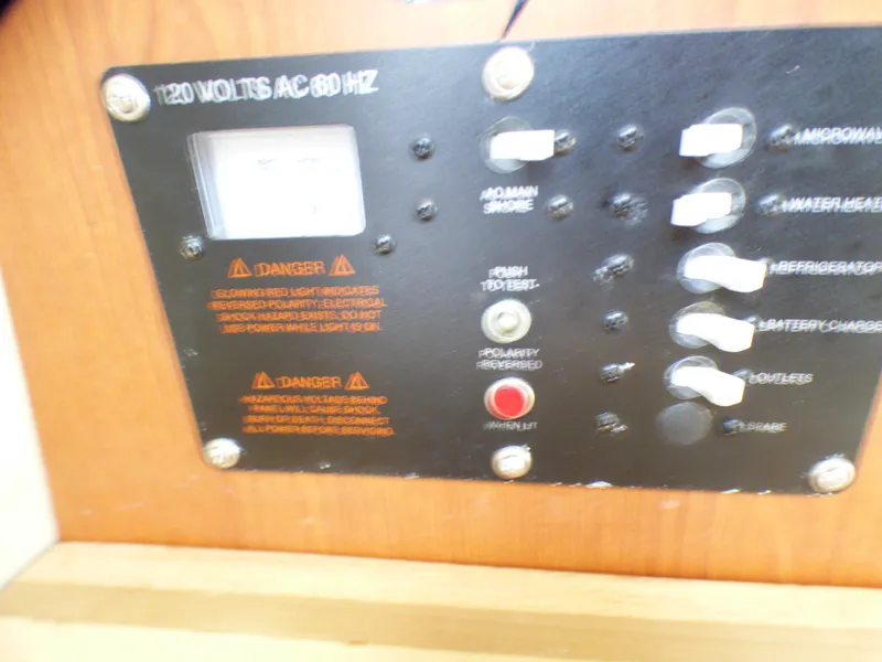 Slide: The Image of Control panel of a 2004 Robalo R265 Walkaround boat, showing electrical switches and warnings. - 40