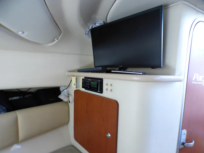 Slide: The Image of 2004 Robalo R265 Walkaround cabin interior with TV and storage cabinet. - 7