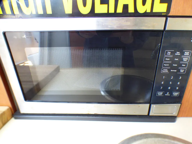 Slide: The Image of Microwave oven inside a 2004 Robalo R265 Walkaround boat kitchen area. - 9