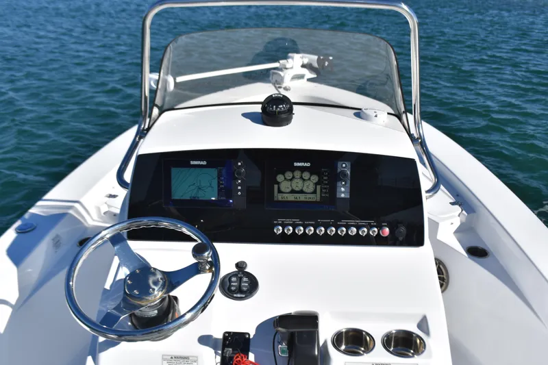 Slide: The Image of 2015 Sportsman Masters 227 Bay Boat dashboard with navigation system on water. - 10