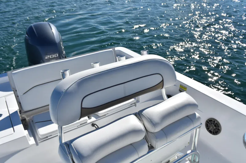 Slide: The Image of 2015 Sportsman Masters 227 Bay Boat with cushioned seating and Yamaha 200 engine on sparkling water. - 11