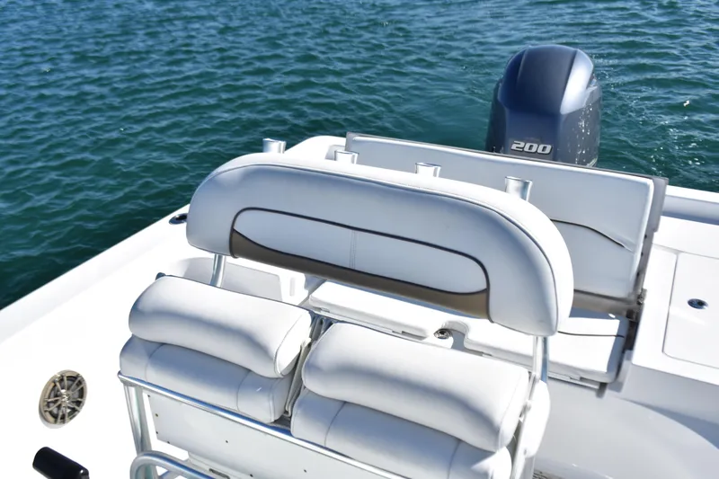 Slide: The Image of 2015 Sportsman Masters 227 Bay Boat with cushioned seating and powerful outboard motor. - 12