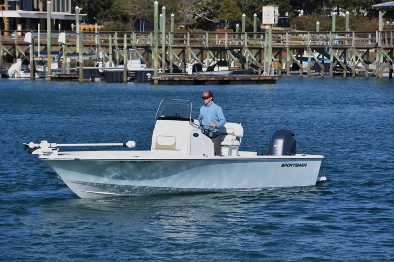 Slide: The Image of 2015 Sportsman Masters 227 Bay Boat cruising on a sunny day near a marina. - 2