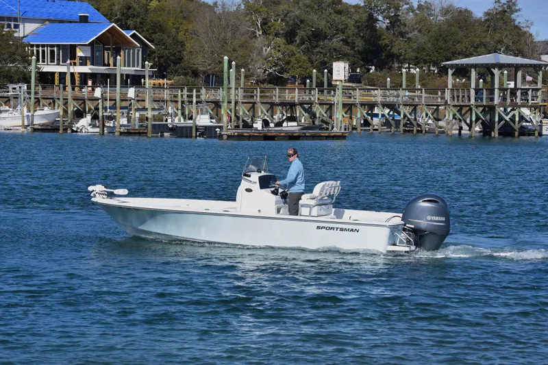 Slide: The Image of 2015 Sportsman Masters 227 Bay Boat cruising near a dock on a sunny day. - 3