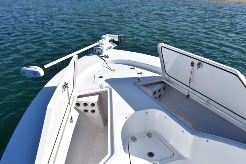 Slide: The Image of 2015 Sportsman Masters 227 Bay Boat with open storage compartments on calm water. - 7