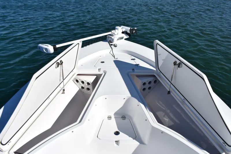 Slide: The Image of 2015 Sportsman Masters 227 Bay Boat deck with open storage compartments on water. - 8