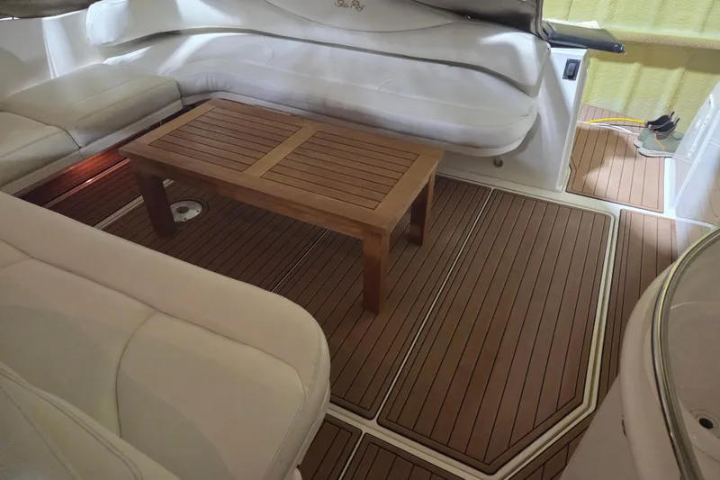 Slide: The Image of Interior of 2000 Sea Ray 410 Sundancer with wooden table and cushioned seating. - 10