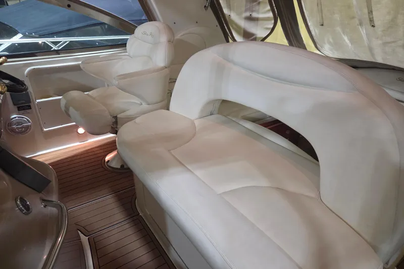 Slide: The Image of Luxurious interior of 2000 Sea Ray 410 Sundancer with white leather seating and wood flooring. - 11
