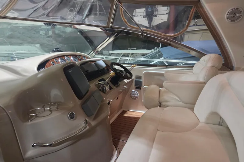 Slide: The Image of Interior of 2000 Sea Ray 410 Sundancer yacht with luxurious seating and modern dashboard. - 13