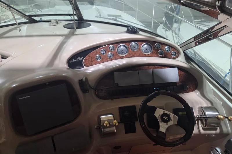 Slide: The Image of Cockpit of 2000 Sea Ray 410 Sundancer with steering wheel and instrument panel. - 14