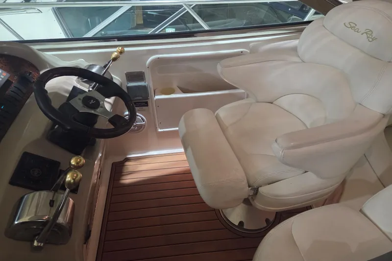 Slide: The Image of Interior of 2000 Sea Ray 410 Sundancer with steering wheel and captain's chair. - 18