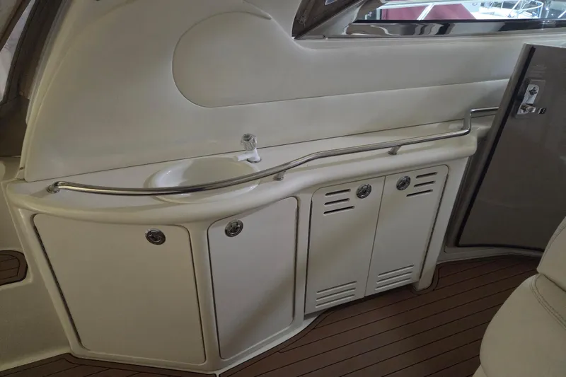 Slide: The Image of 2000 Sea Ray 410 Sundancer interior with sink and storage cabinets. - 19