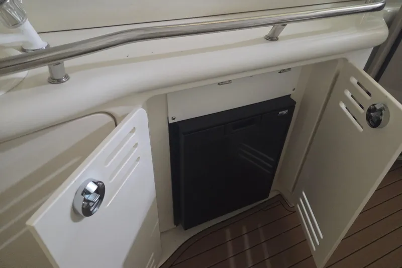 Slide: The Image of 2000 Sea Ray 410 Sundancer boat interior with open storage compartments and railing. - 20