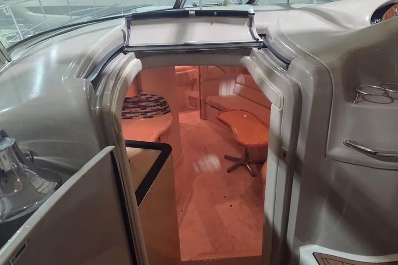 Slide: The Image of Interior view of 2000 Sea Ray 410 Sundancer yacht, featuring cozy seating and elegant design. - 21